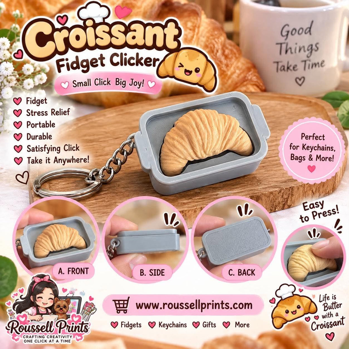Golden croissant fidget clicker keychain inside a small gray tray-style case with metal keyring