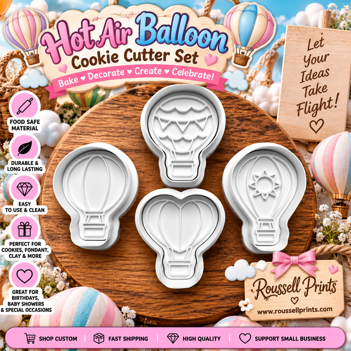 Four-piece hot air balloon cookie cutter set with balloon, banner, and sun designs shown on a wooden board
