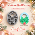Mistletoe Oval Earring Physical Clay Cutter by Roussell Prints – oval shape with holly leaf cutout and finished light blue clay earring example with green leaves and pink berries