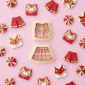 Cheerleader uniform clay cutter set with colorful finished polymer clay charms on pink background