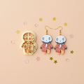 Skeleton businessman clay cutter with finished earring sample on peach background