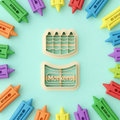 Crayon and markers clay cutter set with colorful finished polymer clay charms on mint background