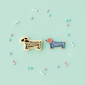 Skeleton dachshund clay cutter with finished polymer clay charm on mint green background