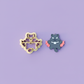 Vampire kitty clay cutter with finished polymer clay charm on purple background